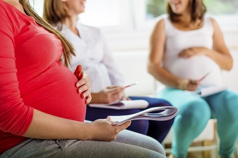 Three pregnant women in a class