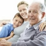 Senior man sitting with his family