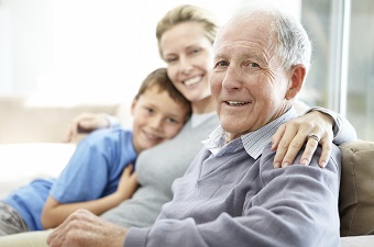 Senior man sitting with his family